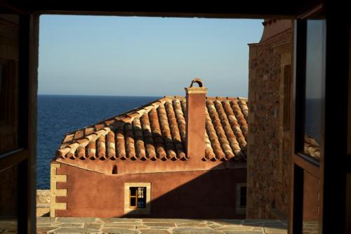 a view of a building with the ocean in the background at Theophano Art Hotel in Monemvasia