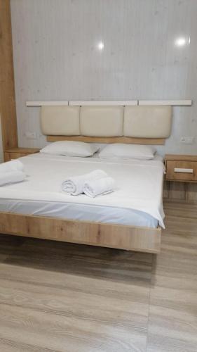 a bed with two white towels on top of it at Kai Hotel Bar in Tbilisi City
