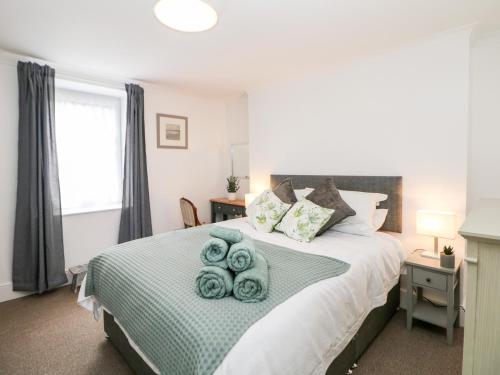 a bedroom with a bed with towels on it at Garden Apartment in Buxton