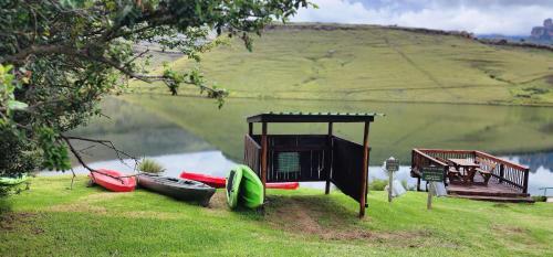 a group of boats on the shore of a lake at Gooderson Drakensberg Gardens Golf & Spa Resort in Drakensberg Garden