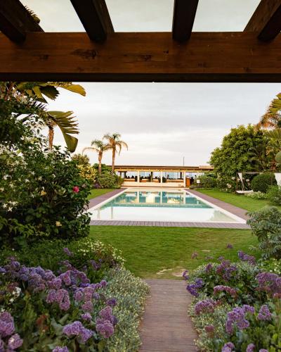 a view of a garden with a swimming pool at Sant Efis Hotel in Pula