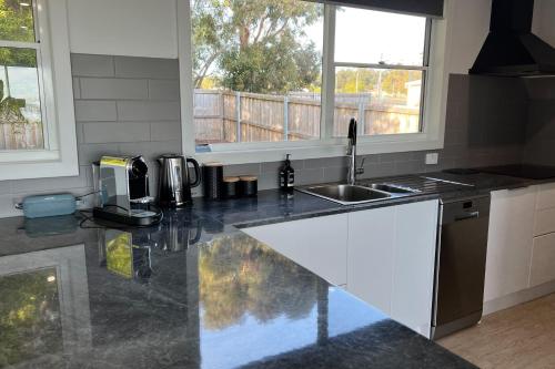 a kitchen with a sink and a counter top at BINALONG BRAE @ Bay of Fires Two bedroom both with ensuites in Binalong Bay