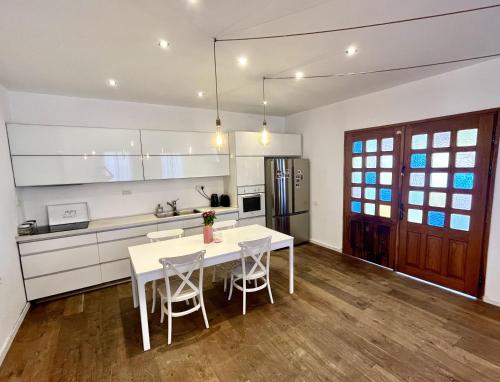 a kitchen with a white table and chairs at Neve Tsedek Rooftop in Tel Aviv