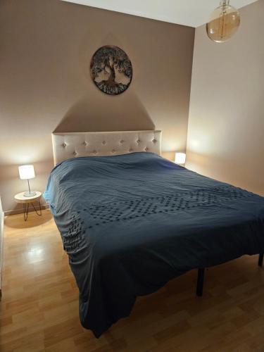 a bedroom with a bed and a clock on the wall at La citadelle in Nyons