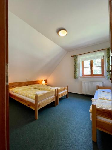 a bedroom with two beds and a window at Třetí chalupa U Smrčiny in Janske Lazne