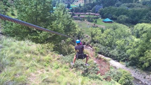 a person on a hill with a zip line at Gooderson Drakensberg Gardens Golf & Spa Resort in Drakensberg Garden