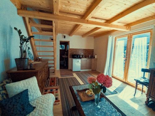 a living room with a table with a vase of flowers at Guest house Nizama's Place in Sarajevo