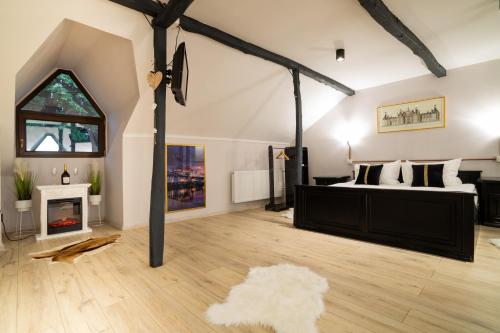 a bedroom with a bed and a fireplace in a room at i3 Boutique Apart in Bacău