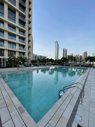 a large swimming pool in the middle of a building at Luxurious one-bedroom very close to Dubai Mall in Dubai
