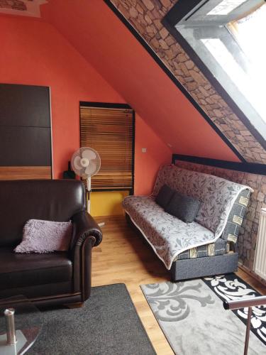 a living room with a bed and a couch at Samostatný domeček in Klášterec nad Ohří