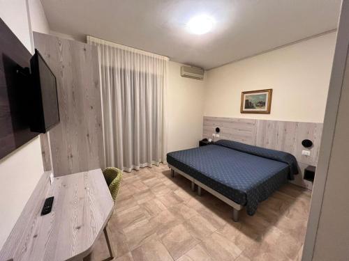 a bedroom with a bed and a flat screen tv at Hotel Colonna in Albignasego