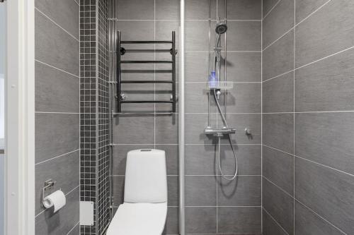 a bathroom with a shower with a toilet in it at Studio - nearby centrum & metro in Helsinki