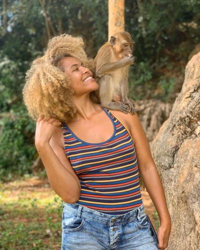 a woman with a monkey on her shoulders at Khao Sok Green Mountain View in Khao Sok