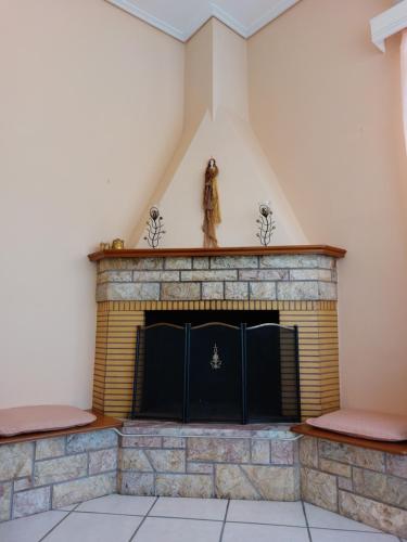 a brick fireplace with a statue on top of it at Oranje Guesthouse in Itea