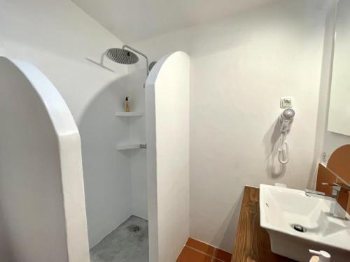 y baño blanco con lavabo y ducha. en Montes de Charme (AL 6288) en Avis