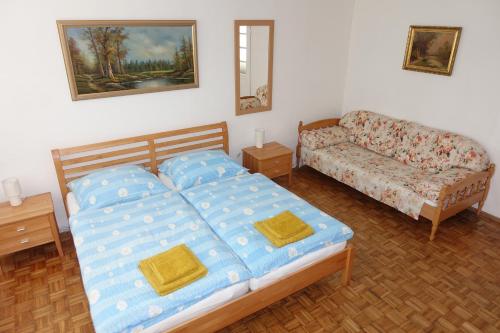 ein Schlafzimmer mit einem Bett und einem Sofa in der Unterkunft Alla in Kittsee