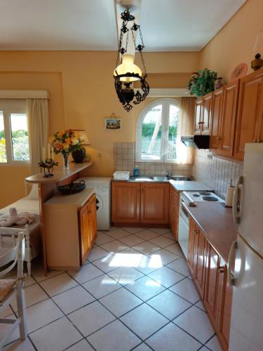 a kitchen with a sink and a refrigerator at Oranje Guesthouse in Itea