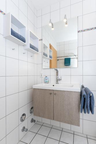 a bathroom with a sink and a mirror at Ferienwohnung Inselblick in Bensersiel