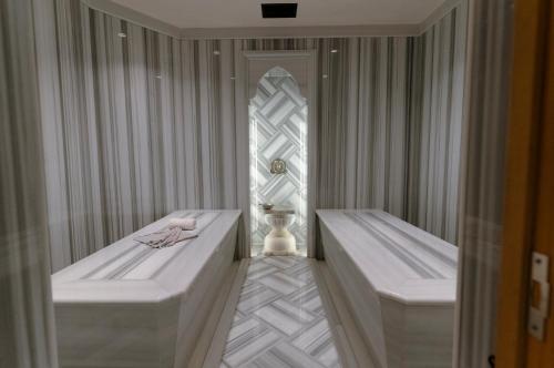 a spa room with two beds and a window at Swissôtel Living Bodrum in Bodrum City