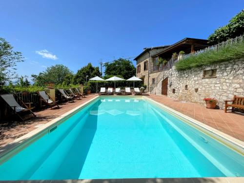 a swimming pool with blue water in front of a building at Torretta sleeps 5 with pool and exclusive gardens plus private verandah in Strettura