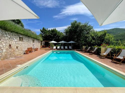 an outdoor swimming pool with chairs and umbrellas at Torretta sleeps 5 with pool and exclusive gardens plus private verandah in Strettura