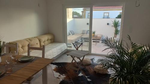 a living room with a couch and a table at Casa Lusitano by Valada Village in Valada