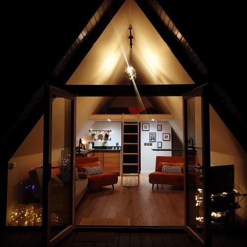 a living room with a large room with a roof at The Hut 45 in Newry