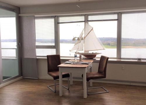 a dining room with a table with a sail boat on it at Ferienwohnung-Seemoewe in Schleswig