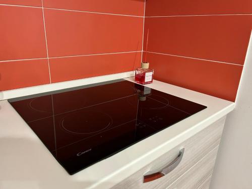 a bathroom with red walls and a black counter top at LE FONTI - CHARMING APARTMENT - PUGLIA INN HOLIDAY in Acquaviva delle Fonti