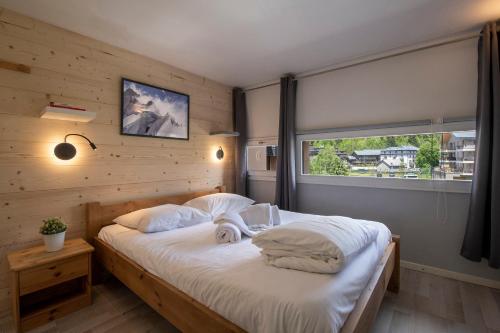 מיטה או מיטות בחדר ב-Résidence Grand Roc - Campanules 311 - Happy Rentals