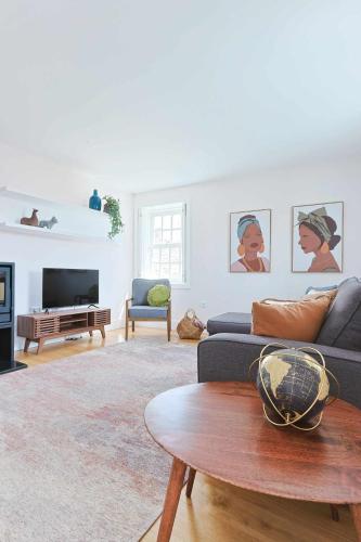 a living room with a couch and a table at Downtown Charming Apartments - Apartamento Ponte in Chaves