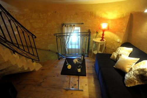 a living room with a couch and a table at Clos Moulin Du Cadet in Saint-Émilion