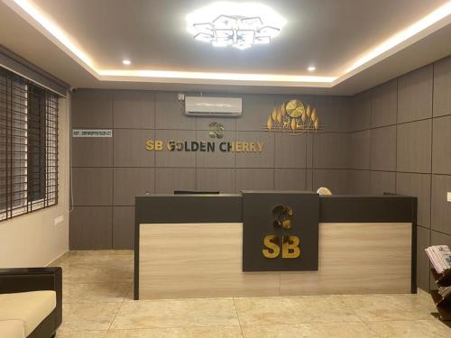 a lobby with a sbi golden cheery sign on the wall at SB Golden Cherry in Yelahanka