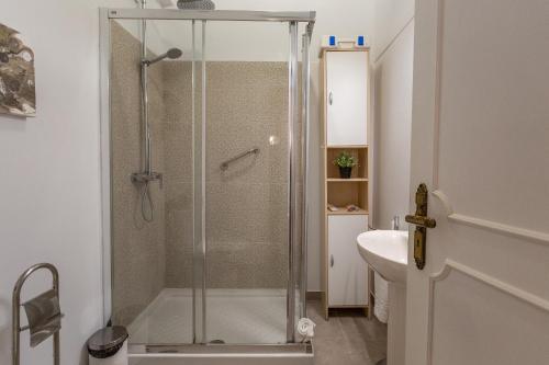 a bathroom with a shower with a glass door at BeGuest Gandarinha Apartment in Cascais