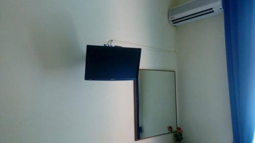 a mirror on the wall of a room at Hotel Greco in Milan