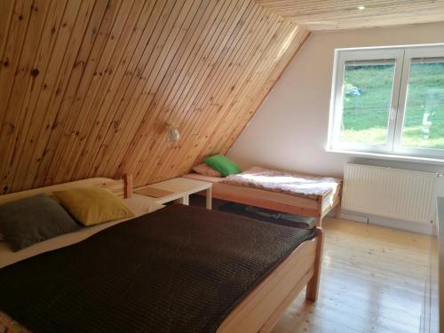 um quarto com duas camas e uma janela em Chalupa Varechovsky potok em Vysoká nad Kysucou
