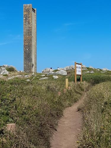 a dirt trail leading to a tower on a hill at Casa da Varanda in Carreço