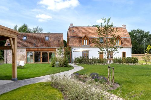 a house with a garden in front of it at 't Hooiland in Lo-Reninge