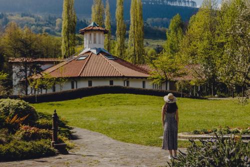 a woman walking down a path towards a building at Amalurra Ecohotel & Retreat Center in Artzentales