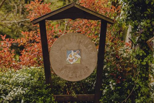 a sign with a crest on it in a garden at Amalurra Ecohotel & Retreat Center in Artzentales