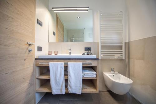 a bathroom with a sink and a mirror at Apartments Chalet Silva in Selva di Val Gardena