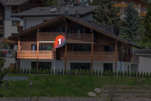 a house with a sign in front of it at Apartments Chalet Silva in Selva di Val Gardena