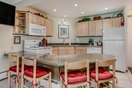 a kitchen with a table and chairs and a refrigerator at Laurelwood Condominiums 406 in Snowmass Village