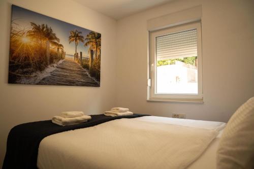 a bedroom with a bed with two towels on it at Luxury and Spa App F in Makarska