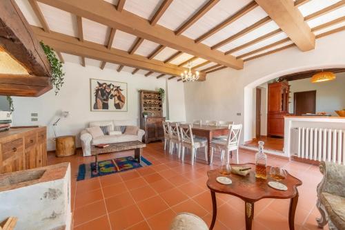 a living room with a table and a dining room at Villa Sunset in Greve in Chianti