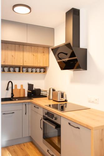 Kuchyň nebo kuchyňský kout v ubytování Nowoczesne apartamenty przy plaży nad Zalewem Szczecińskim w Czarnocinie