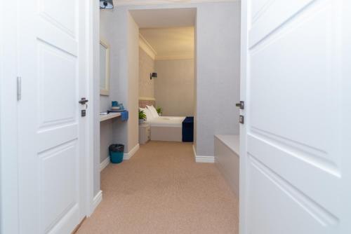 a hallway with a bathroom with a toilet and a sink at Maner hotel in Odesa