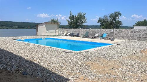 a small swimming pool on a rocky area next to the water at La Ponton AdaKale in Vrancea