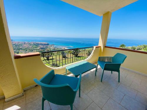 a balcony with chairs and a view of the ocean at Marasusa Apartments Maestrale 216C in Parghelia