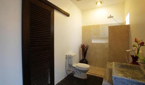 a bathroom with a toilet next to a sink at Residence Indochine D'angkor in Siem Reap